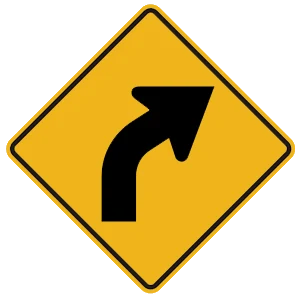 Road sign: An upcoming curve in the road.