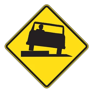Road sign: Low shoulder.