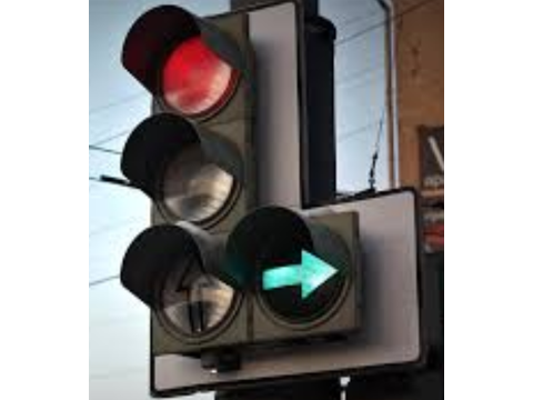 When approaching an intersection with a traffic signal showing a green right-turn arrow AND a red light, the driver: